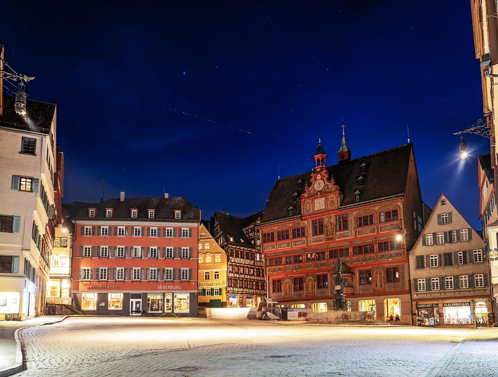 Starlink satellite trails crossing the night sky above the town hall in Tübingen