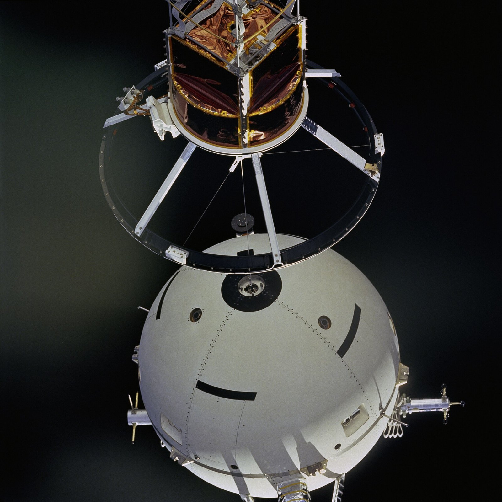 A thin Kevlar tether stretching into black space from the Shuttle payload bay
